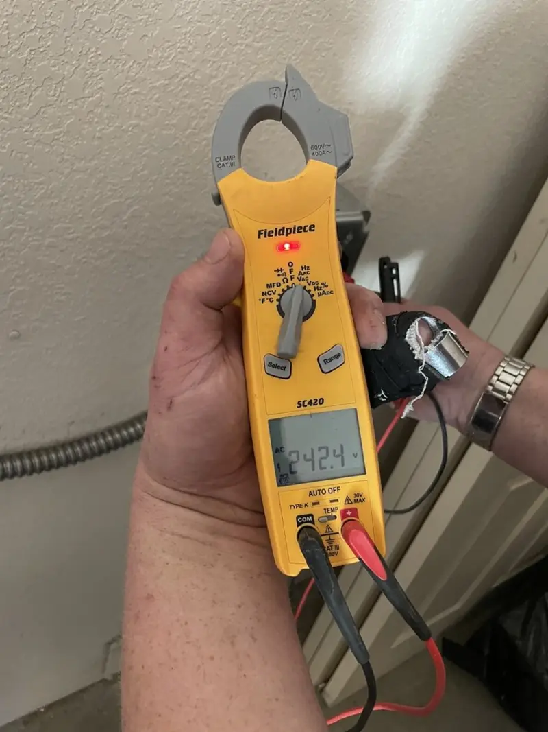 Voltage testing with clamp meter during Ceiling Fan Installation in Conestoga